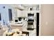 Open kitchen with stainless steel appliances, granite countertop and a view to the living room at 1990 Erving Cir # 201, Ocoee, FL 34761