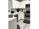 Modern kitchen featuring white cabinets, stainless steel appliances, and grey tone flooring at 1990 Erving Cir # 201, Ocoee, FL 34761