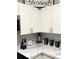 Bright kitchen with white cabinets, granite counters and mosaic backsplash at 1990 Erving Cir # 201, Ocoee, FL 34761