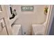 Practical laundry area with washer, dryer, storage shelf and a decorative 'Laundry' sign at 1990 Erving Cir # 201, Ocoee, FL 34761
