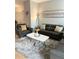 Relaxing living room with a plush gray rug, leather furniture, and modern decor at 1990 Erving Cir # 201, Ocoee, FL 34761