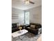 Comfortable living room with soft gray rug and modern ceiling fan above at 1990 Erving Cir # 201, Ocoee, FL 34761