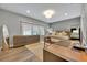 Neutral bedroom featuring a large window, sleek dresser, and hardwood floors at 727 Park Lake Cir, Orlando, FL 32803