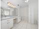 Well-lit bathroom with double sinks, ample counter space, and a large mirror at 20505 Queen Alexandra Dr, Leesburg, FL 34748