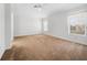 Spacious bedroom with neutral carpeting and large windows at 20505 Queen Alexandra Dr, Leesburg, FL 34748