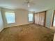 Empty bedroom with a ceiling fan, windows, and sliding glass doors leading to the outside at 20505 Queen Alexandra Dr, Leesburg, FL 34748