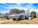 Single-story home with attached garage and landscaped yard at 20505 Queen Alexandra Dr, Leesburg, FL 34748