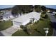 Aerial view of a single-story home with a well-manicured lawn and mature landscaping at 20505 Queen Alexandra Dr, Leesburg, FL 34748