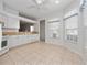 Kitchen with white cabinets and tile floor at 20505 Queen Alexandra Dr, Leesburg, FL 34748