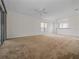 Spacious living room with light walls, neutral carpeting, and access to a patio at 20505 Queen Alexandra Dr, Leesburg, FL 34748