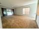 Spacious living room features sliding doors and a large window for plenty of natural light at 20505 Queen Alexandra Dr, Leesburg, FL 34748