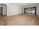 Bright and airy living room with carpet, sliding doors to a patio, and a view to hallway at 20505 Queen Alexandra Dr, Leesburg, FL 34748