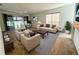 Bright living room with a large window, modern furnishings, and adjacent dining area at 20505 Queen Alexandra Dr, Leesburg, FL 34748