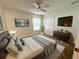 Cozy bedroom with a comfortable bed, mounted TV, and ample closet space at 20505 Queen Alexandra Dr, Leesburg, FL 34748