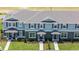 Charming townhomes with blue exteriors, gray shutters, and well-manicured lawns at 2738 Flushing Dr, Apopka, FL 32703