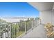 Relaxing balcony with table and chairs offers a view of the lake at 13427 Blue Heron Beach Dr # 405, Orlando, FL 32821