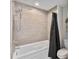 Cozy bathroom featuring a shower and tub combination, neutral tiling, and modern fixtures at 13427 Blue Heron Beach Dr # 405, Orlando, FL 32821