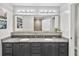 Elegant bathroom with a double vanity, granite countertop, and decorative lighting at 13427 Blue Heron Beach Dr # 405, Orlando, FL 32821