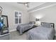 Neutral bedroom featuring two twin beds with gray bedding and a ceiling fan above at 13427 Blue Heron Beach Dr # 405, Orlando, FL 32821
