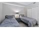 Neutral bedroom featuring two twin beds with gray bedding and a closet at 13427 Blue Heron Beach Dr # 405, Orlando, FL 32821