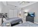Bright bedroom featuring two twin beds with gray bedding and a view into another room at 13427 Blue Heron Beach Dr # 405, Orlando, FL 32821