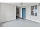 A bright hallway featuring a blue door, neutral walls and floor, with natural light at 13427 Blue Heron Beach Dr # 405, Orlando, FL 32821