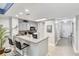 A kitchen with a breakfast bar, gray cabinets, and stainless steel appliances at 13427 Blue Heron Beach Dr # 405, Orlando, FL 32821