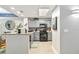 Modern kitchen features gray cabinets, breakfast bar, updated appliances and neutral decor at 13427 Blue Heron Beach Dr # 405, Orlando, FL 32821