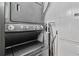 Laundry room showcasing stacked washer and dryer units, along with an ironing board at 13427 Blue Heron Beach Dr # 405, Orlando, FL 32821