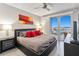 Comfortable main bedroom with a view of the water, ceiling fan and modern decor at 13427 Blue Heron Beach Dr # 405, Orlando, FL 32821