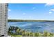 Beautiful water view from a high-rise building, featuring trees and boats on a sunny day at 13427 Blue Heron Beach Dr # 405, Orlando, FL 32821