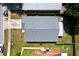 An aerial view showcases a home with a gray roof, complemented by a green lawn at 4316 Natchez Trace Dr, St Cloud, FL 34769