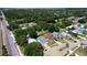 Aerial view of a neighborhood surrounded by lush trees and a small lake at 4316 Natchez Trace Dr, St Cloud, FL 34769