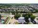 Aerial view of a meticulously planned community featuring verdant trees, various homes and wide roads at 4316 Natchez Trace Dr, St Cloud, FL 34769
