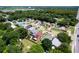 An aerial view of a lush, tree-filled neighborhood with well-maintained homes, some with backyard pools at 4316 Natchez Trace Dr, St Cloud, FL 34769