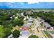 Aerial view of a residential area with lush green trees, a pond and many neighborhood homes at 4316 Natchez Trace Dr, St Cloud, FL 34769