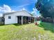 Spacious backyard featuring a screened-in porch, play set, and lush lawn at 4316 Natchez Trace Dr, St Cloud, FL 34769