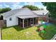 Lush backyard features a screened porch, a small play set, and shade trees at 4316 Natchez Trace Dr, St Cloud, FL 34769