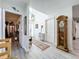 Bright entryway featuring hardwood style flooring, a tall clock, and a view to other rooms in the home at 4316 Natchez Trace Dr, St Cloud, FL 34769