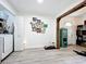Hallway featuring a gallery wall, access to laundry, and a doorway to the main living area at 4316 Natchez Trace Dr, St Cloud, FL 34769