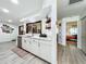 Bright kitchen featuring white cabinets, stainless steel appliances and an open floorplan to the living area at 4316 Natchez Trace Dr, St Cloud, FL 34769