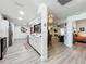 Open kitchen with stainless steel appliances, white cabinetry, and adjacent living area at 4316 Natchez Trace Dr, St Cloud, FL 34769