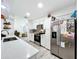 Bright kitchen with white cabinets, stainless steel appliances, and open access to adjacent living spaces at 4316 Natchez Trace Dr, St Cloud, FL 34769