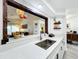 Kitchen featuring white countertops, stainless steel sink, and a pass-through window to the living room at 4316 Natchez Trace Dr, St Cloud, FL 34769