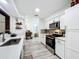 Kitchen featuring white cabinets, stainless steel appliances, and a pass-through to another room at 4316 Natchez Trace Dr, St Cloud, FL 34769