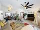 Inviting living room featuring hardwood floors, a dining area, and a large ceiling fan at 4316 Natchez Trace Dr, St Cloud, FL 34769