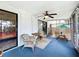 Cozy screened-in porch with wicker furniture and a tranquil outdoor space at 4316 Natchez Trace Dr, St Cloud, FL 34769