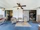 Inviting screened porch with comfortable seating, a fan, and outdoor access at 4316 Natchez Trace Dr, St Cloud, FL 34769
