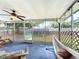 Relaxing screened porch with ceiling fan, hammock, and comfortable seating area at 4316 Natchez Trace Dr, St Cloud, FL 34769