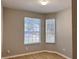 Bedroom featuring neutral walls, modern flooring, and two windows letting in natural light at 3224 Dante Dr # 108, Orlando, FL 32835